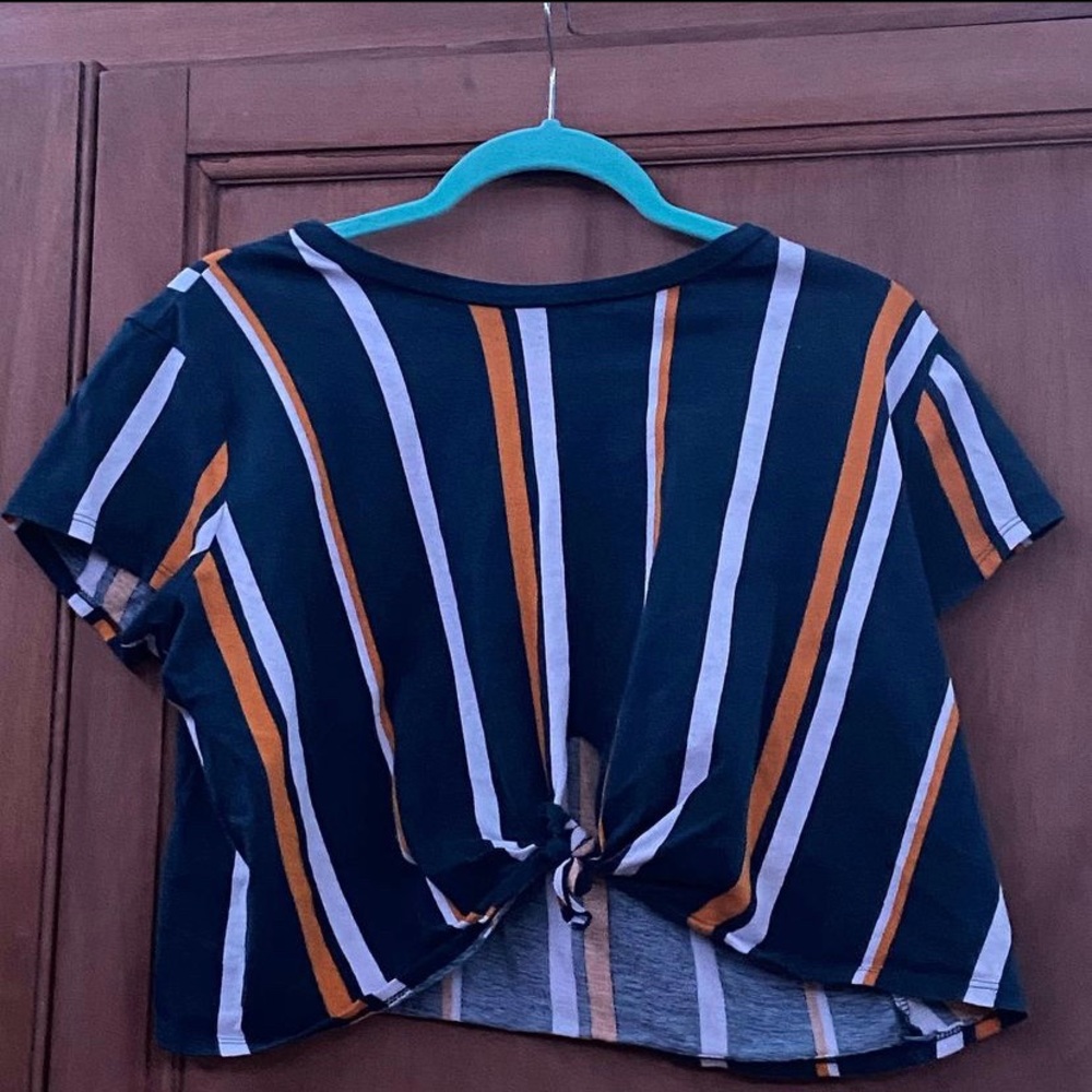 stripped shirt with a tie knot in the front